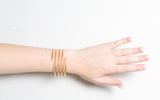 Woman wearing Vintage 1970s Spiral Matte Gold Bracelet
